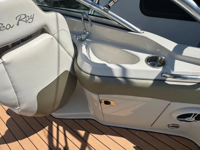 Slide: The Image of 2007 Sea Ray 220 Sundeck interior with sink and seating, showcasing luxury boat features. - 11