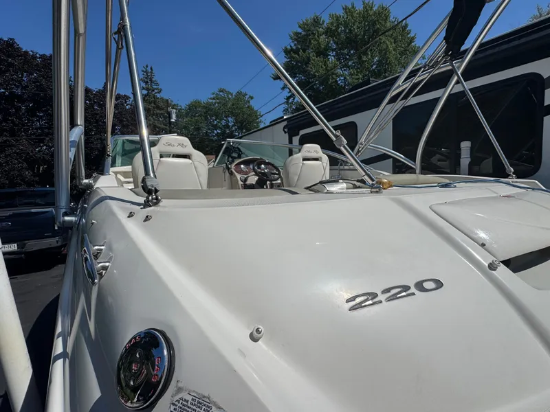 Slide: The Image of 2007 Sea Ray 220 Sundeck boat with white exterior and visible seating area. - 12