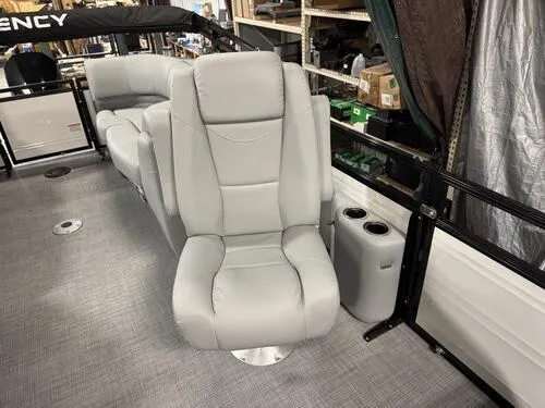 Slide: The Image of 2025 Regency 230 DL3 boat interior with gray seating and cup holders. - 11
