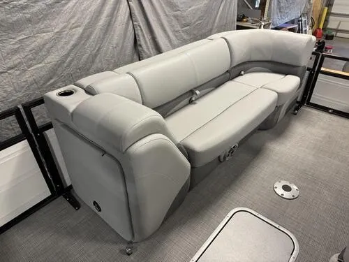 Slide: The Image of 2025 Regency 230 DL3 boat interior with gray seating and cup holder. - 13