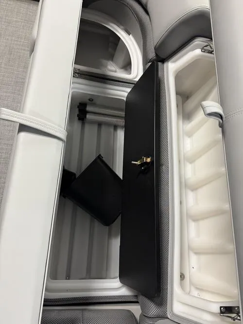 Slide: The Image of Interior storage compartment of 2025 Regency 230 DL3 boat, featuring sleek design and ample space. - 14
