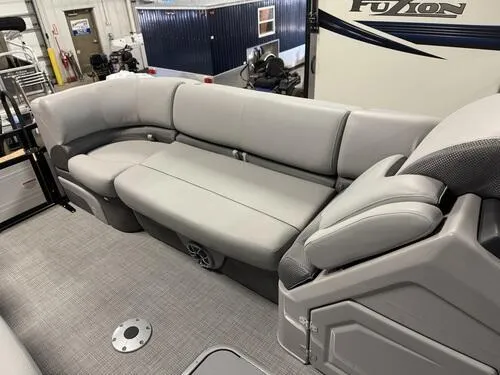 Slide: The Image of 2025 Regency 230 DL3 pontoon boat interior with gray seating and modern design. - 15