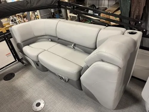 Slide: The Image of 2025 Regency 230 DL3 boat interior with plush gray seating and cup holder. - 6