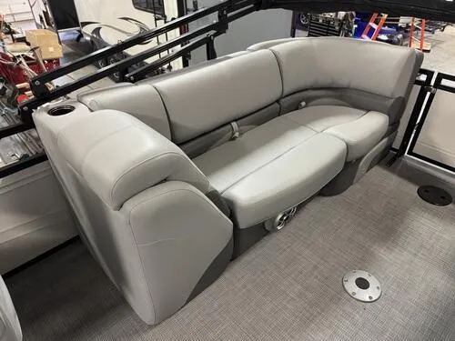 Slide: The Image of 2025 Regency 230 DL3 boat interior with gray cushioned seating and cup holder. - 7