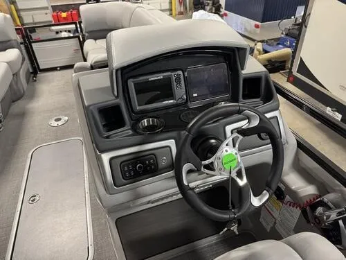 Slide: The Image of 2025 Regency 230 DL3 boat dashboard with steering wheel and control panel. - 9