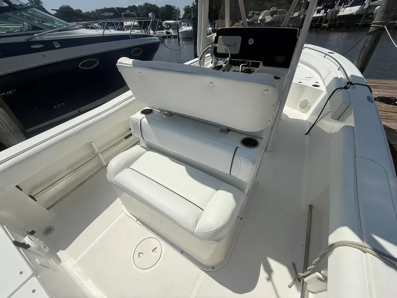 Slide: The Image of 2017 Sea Hunt Ultra 234 boat interior with white seating and steering console. - 10
