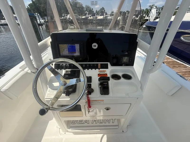 Slide: The Image of 2017 Sea Hunt Ultra 234 boat console with steering wheel and navigation system. - 17