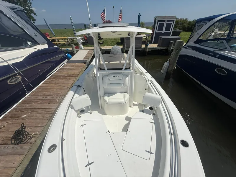 Slide: The Image of 2017 Sea Hunt Ultra 234 boat docked, featuring spacious seating and sleek design. - 19