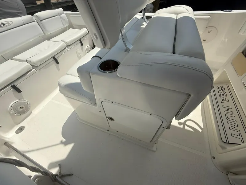 Slide: The Image of 2017 Sea Hunt Ultra 234 boat interior with white seating and cup holder. - 20