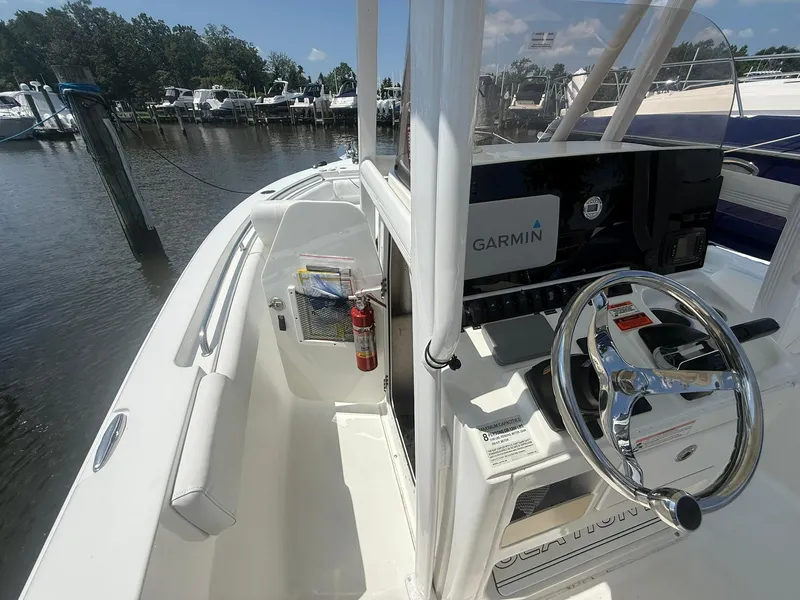 Slide: The Image of 2017 Sea Hunt Ultra 234 boat interior with Garmin navigation, docked at marina. - 22