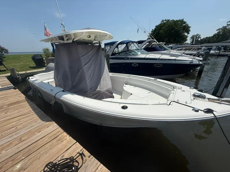 Slide: The Image of 2017 Sea Hunt Ultra 234 boat docked, featuring a white hull and covered console. - 4