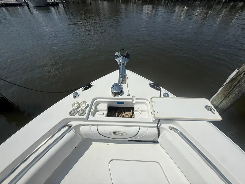 Slide: The Image of 2017 Sea Hunt Ultra 234 boat bow with open storage compartment and anchor. - 6