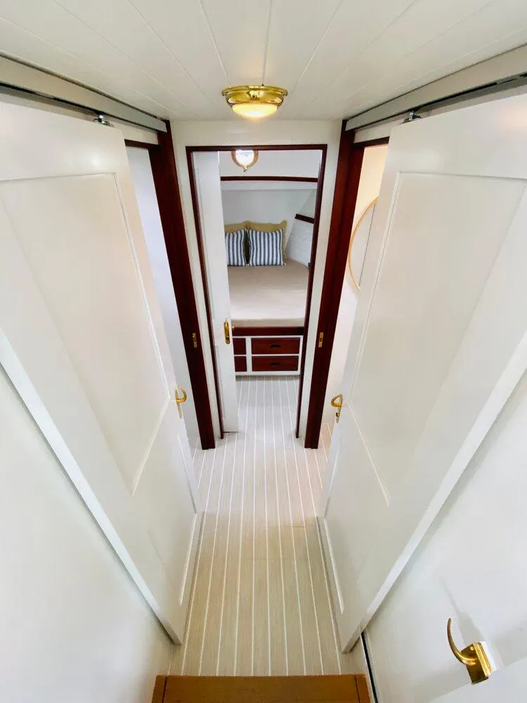 Slide: The Image of Interior of 2021 Mussel Ridge downeast boat, featuring a cozy cabin with striped pillows. - 15