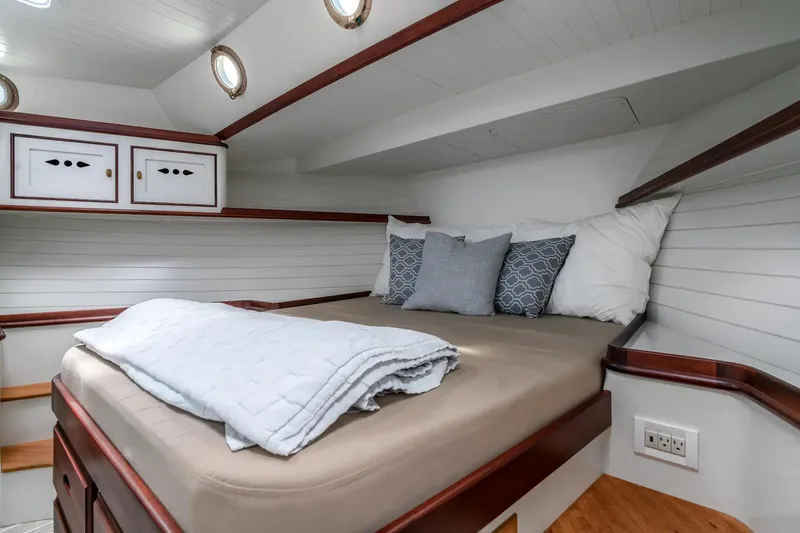Slide: The Image of Cozy cabin interior of 2021 Mussel Ridge Downeast boat with bed and pillows. - 16