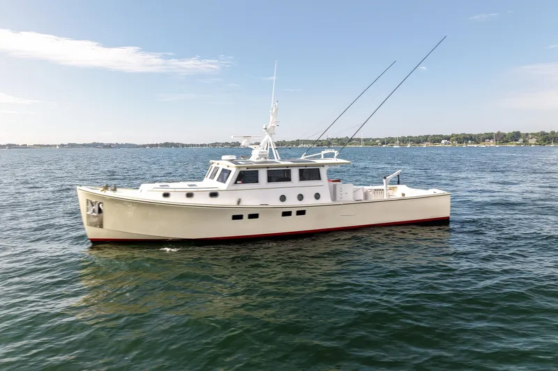 Slide: The Image of 2021 Mussel Ridge Downeast boat on calm water under clear sky. - 2