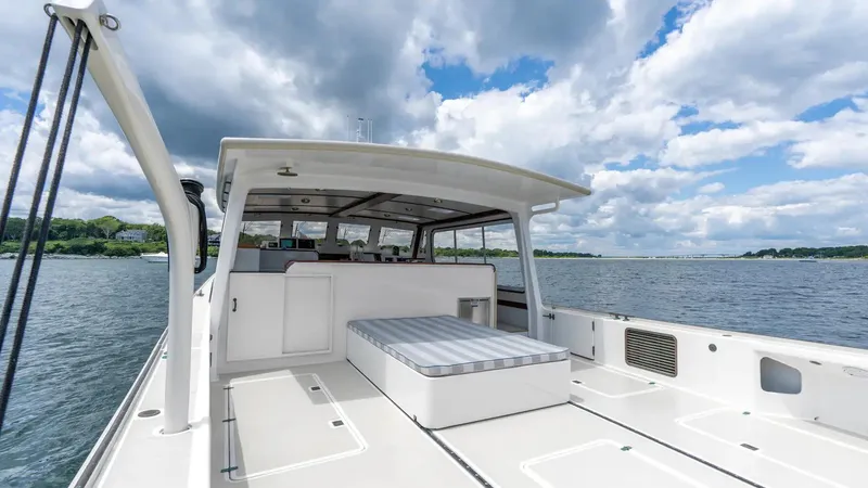 Slide: The Image of 2021 Mussel Ridge Downeast boat on water under cloudy sky. - 20