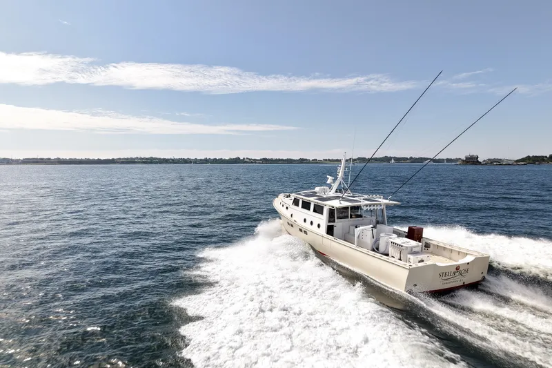 Slide: The Image of 2021 Mussel Ridge Downeast boat cruising on open water under clear skies. - 5