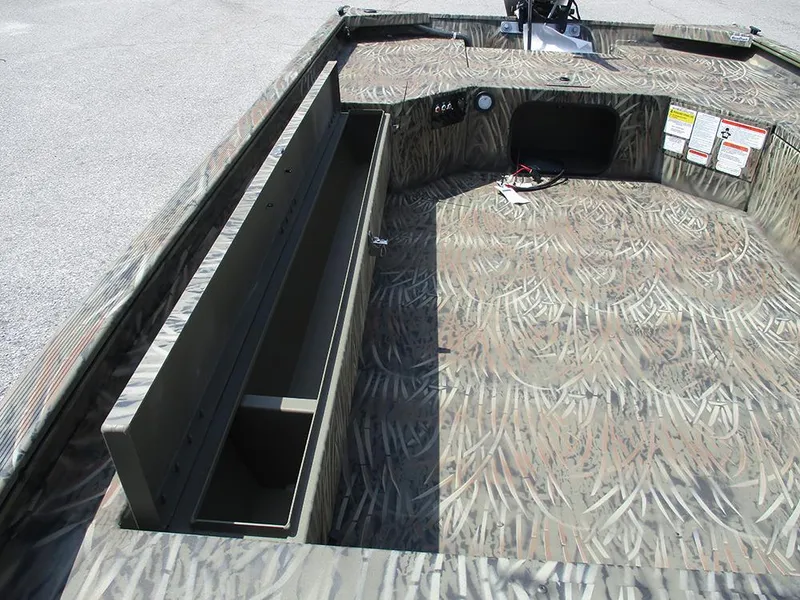 Slide: The Image of 2026 Tracker Grizzly 1654 T Sportsman boat interior with camo pattern and storage compartment. - 14