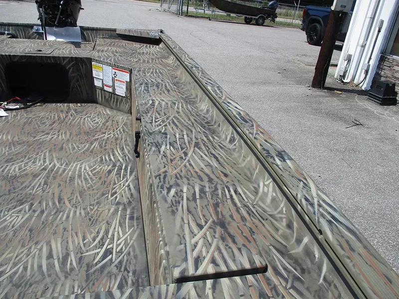 Slide: The Image of 2026 Tracker Grizzly 1654 T Sportsman boat with camouflage pattern deck. - 15