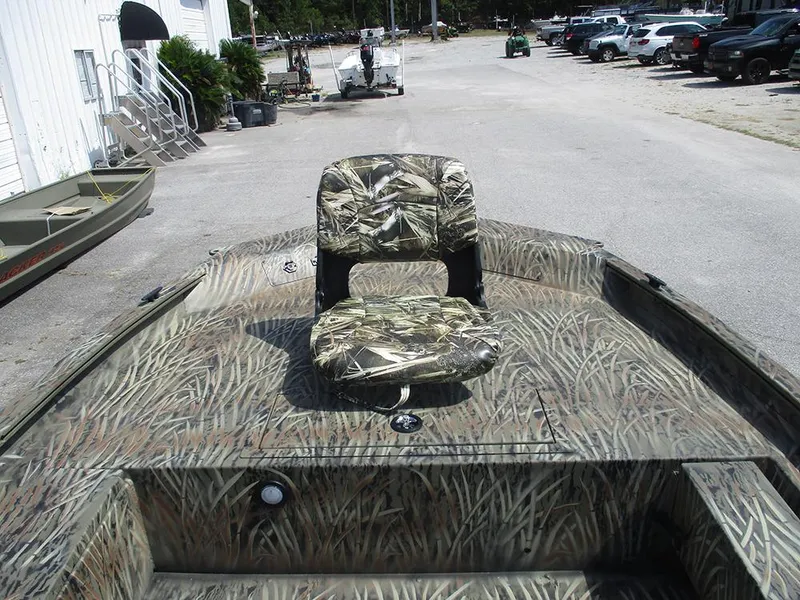 Slide: The Image of Camouflage-patterned seat on 2026 Tracker Grizzly 1654 T Sportsman boat, parked outdoors. - 19