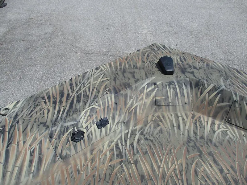 Slide: The Image of 2026 Tracker Grizzly 1654 T Sportsman boat with camouflage pattern on deck. - 20