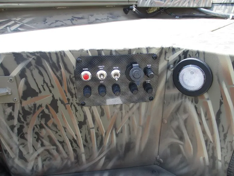 Slide: The Image of Control panel of 2026 Tracker Grizzly 1654 T Sportsman boat with camouflage design. - 21