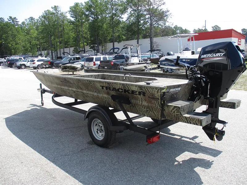 Slide: The Image of 2026 Tracker Grizzly 1654 T Sportsman boat on trailer in parking lot. - 3