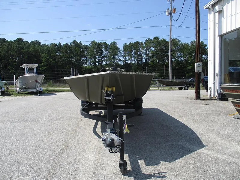 Slide: The Image of 2026 Tracker Grizzly 1654 T Sportsman boat on trailer in outdoor lot. - 4