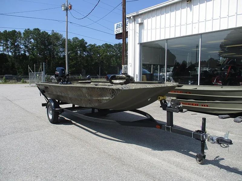 Slide: The Image of 2026 Tracker Grizzly 1654 T Sportsman boat on trailer outside dealership. - 5