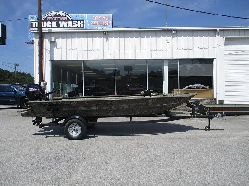 Slide: The Image of 2026 Tracker Grizzly 1654 T Sportsman boat on trailer outside Frontier Truck Wash. - 6