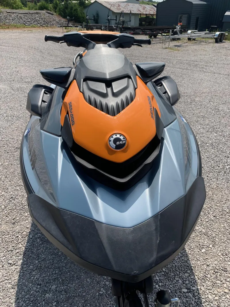 Slide: The Image of 2020 Sea-Doo GTI SE 170 jet ski, orange and gray, parked on gravel. - 2