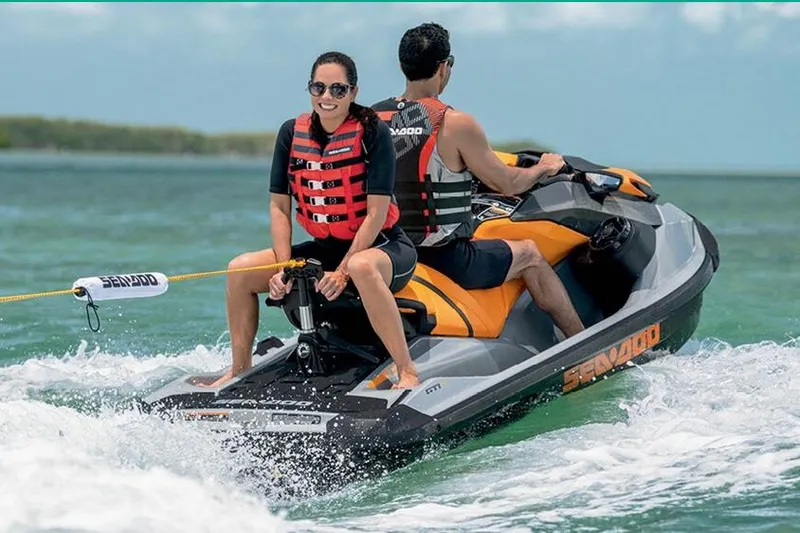 Slide: The Image of Manufacturer Provided Image: 2020 Sea-Doo GTI SE 170 jet ski with two riders enjoying the water. - 8