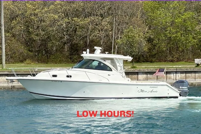 The Image of 2015 Pursuit OS 345 Offshore boat cruising with "Low Hours" text displayed. - 0
