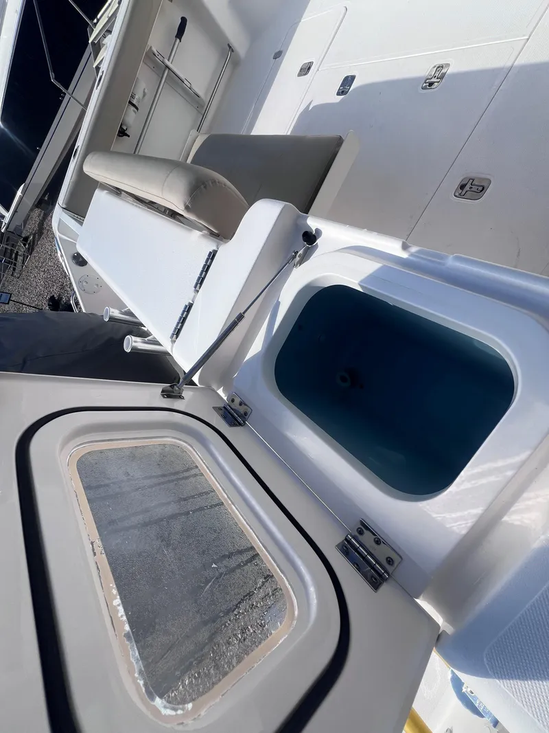 Slide: The Image of 2015 Pursuit OS 345 Offshore boat interior with seating and storage compartments. - 12