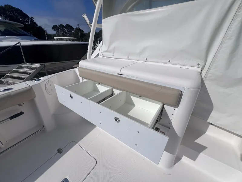 Slide: The Image of 2015 Pursuit OS 345 Offshore boat with open storage compartments on deck. - 20