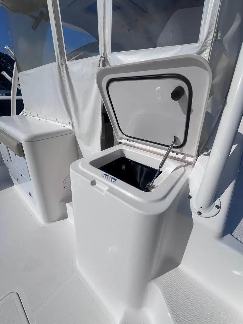 Slide: The Image of 2015 Pursuit OS 345 Offshore boat interior with open storage compartment. - 21