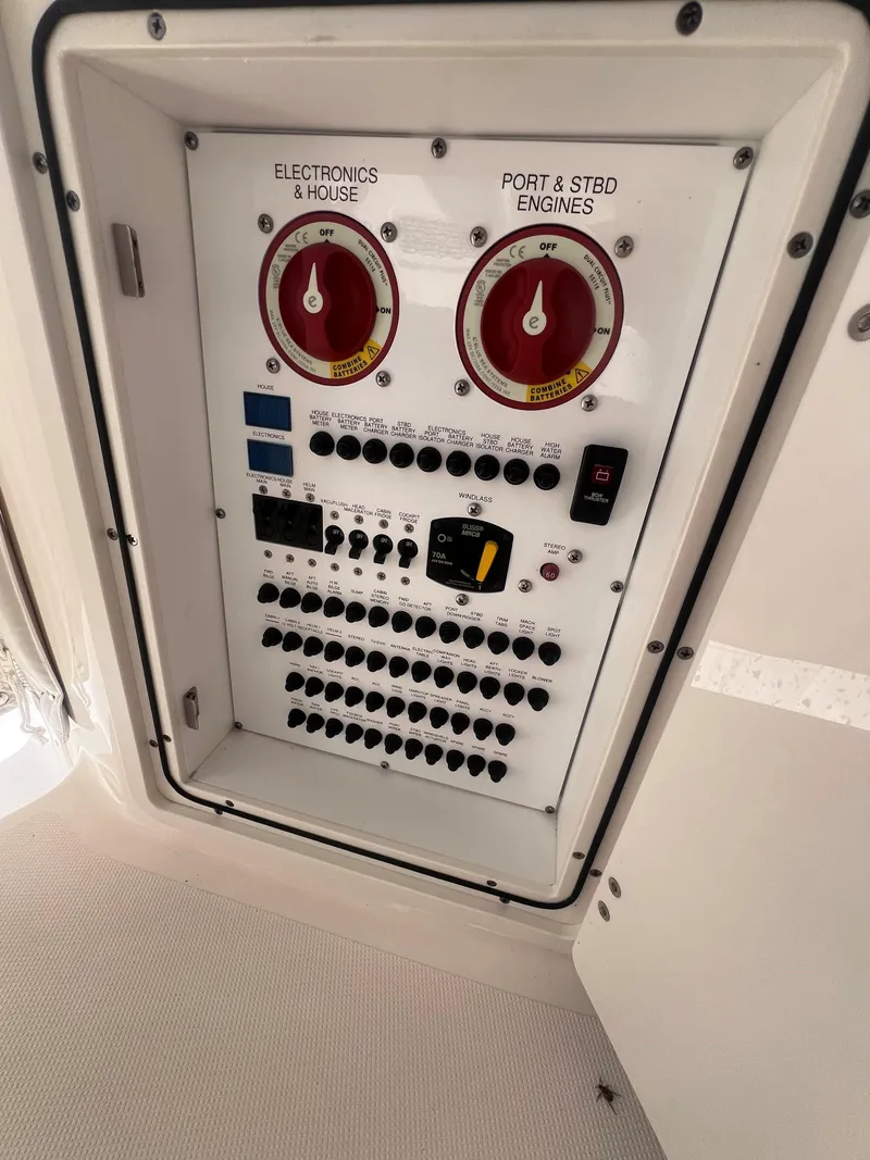 Slide: The Image of Control panel of a 2015 Pursuit OS 345 Offshore boat, featuring switches and dials. - 22