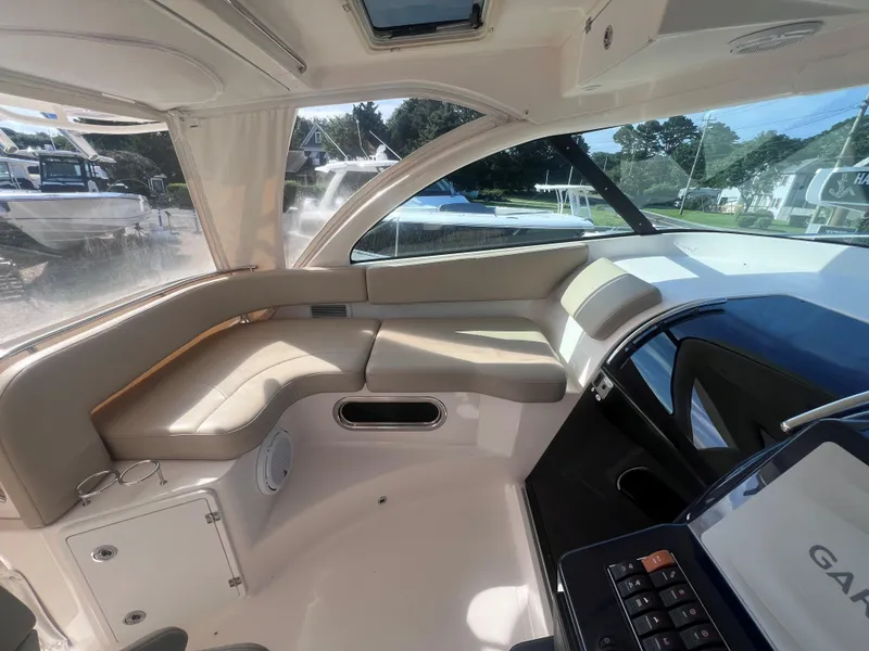 Slide: The Image of Interior of a 2015 Pursuit OS 345 Offshore boat with beige seating and modern design. - 24