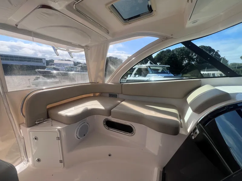Slide: The Image of Interior of 2015 Pursuit OS 345 Offshore boat with cushioned seating and windows. - 25