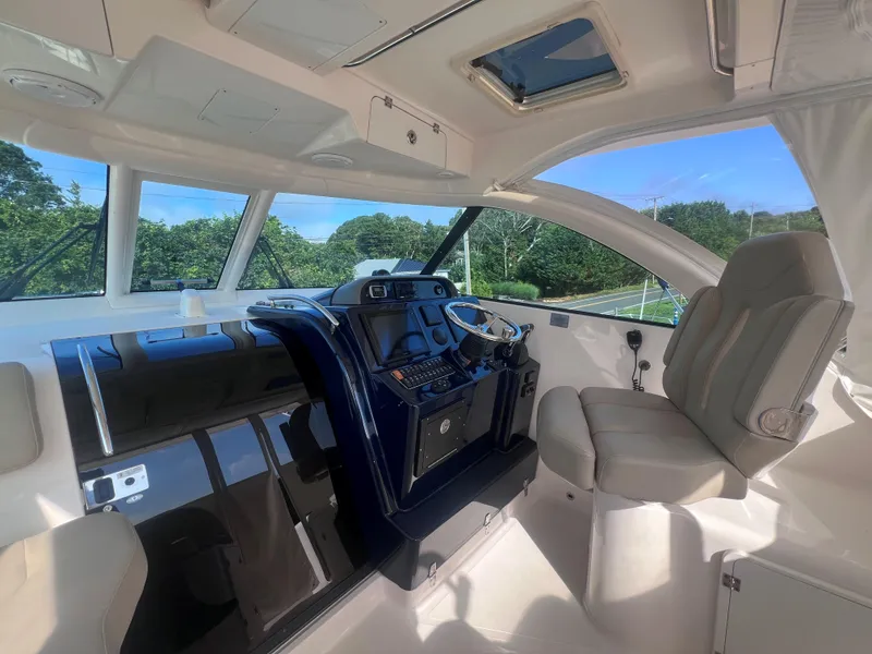 Slide: The Image of 2015 Pursuit OS 345 Offshore boat interior with modern helm and comfortable seating. - 29