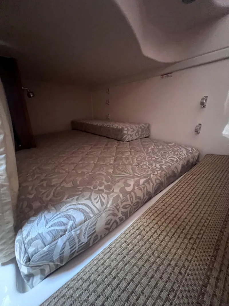 Slide: The Image of Interior cabin of 2015 Pursuit OS 345 Offshore with patterned bedding. - 32