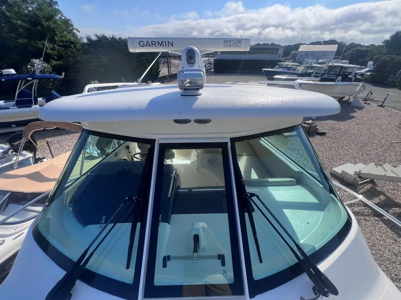 Slide: The Image of 2015 Pursuit OS 345 Offshore boat with Garmin radar, docked in a marina. - 45