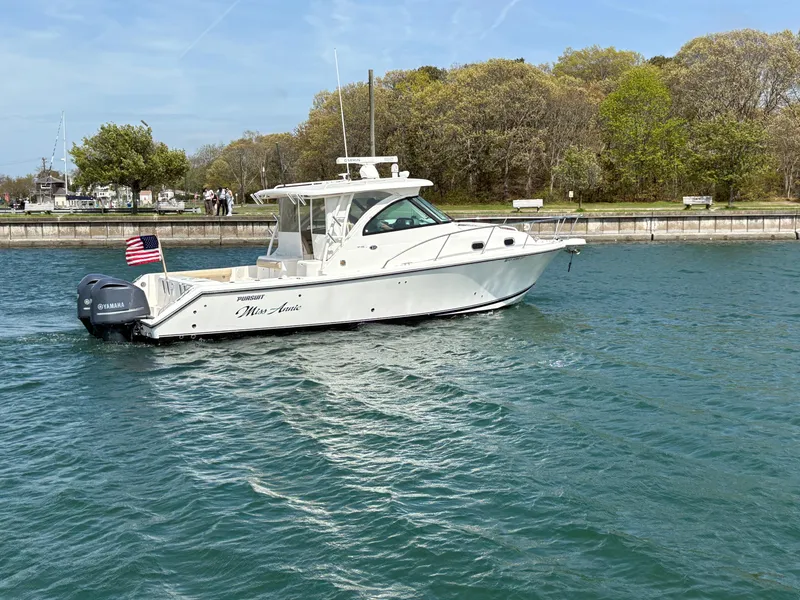 Slide: The Image of 2015 Pursuit OS 345 Offshore boat cruising on a calm waterway. - 48