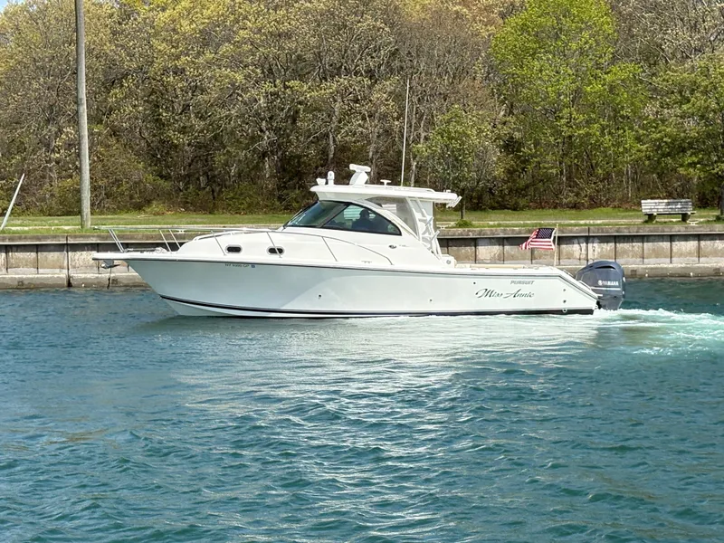 Slide: The Image of 2015 Pursuit OS 345 Offshore boat cruising on a calm waterway. - 5