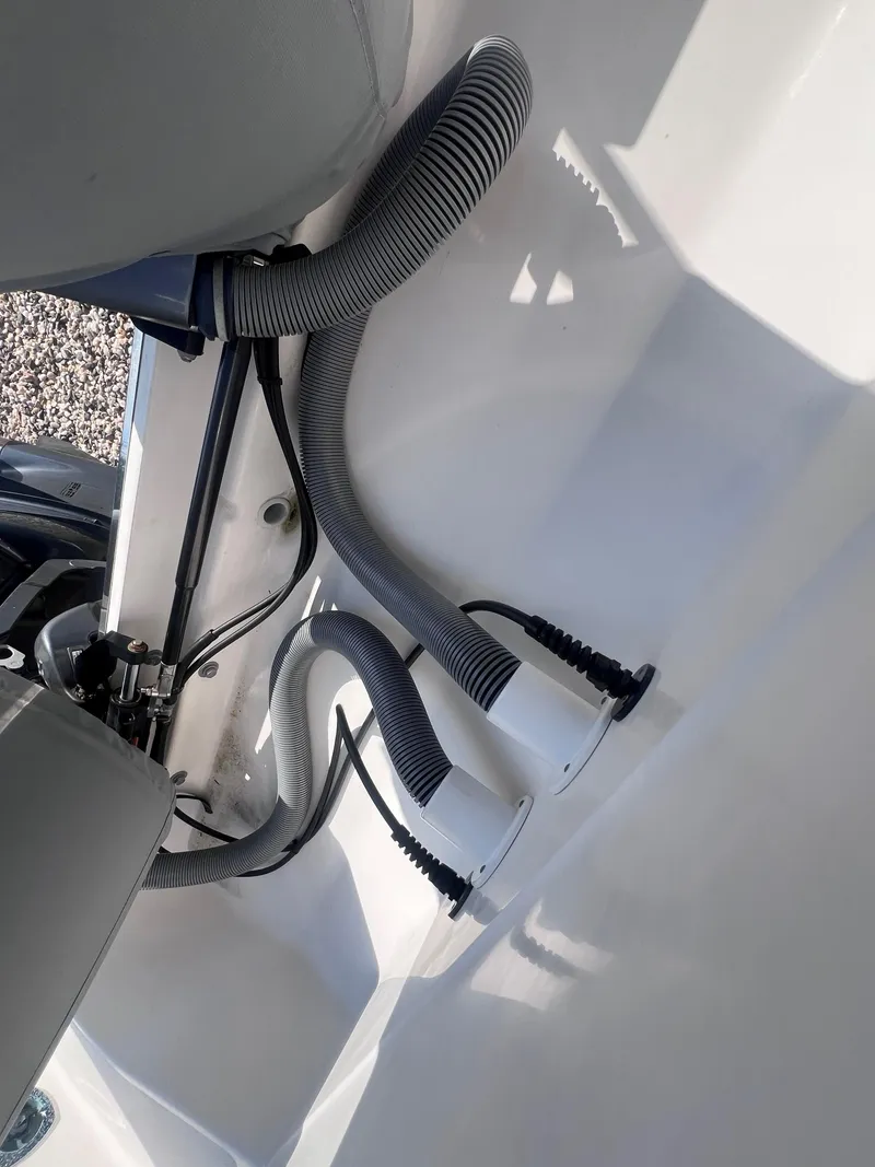 Slide: The Image of 2015 Pursuit OS 345 Offshore boat interior with hoses and mechanical components. - 9