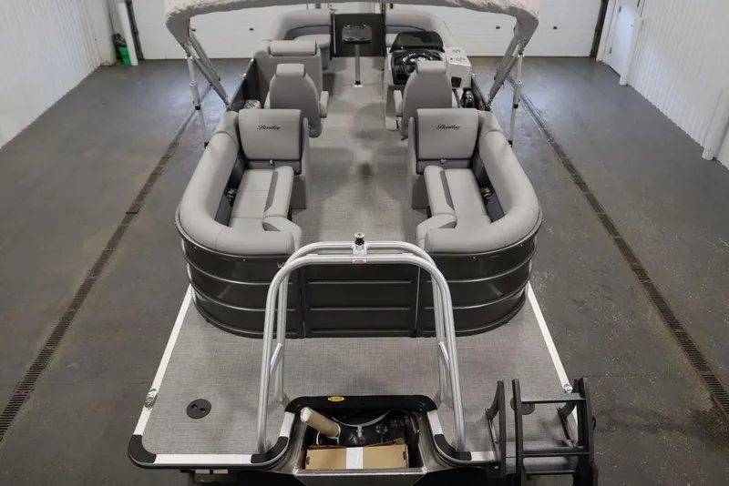 Slide: The Image of 2025 Bentley Pontoons 243 Navigator Tri-toon with spacious seating in a garage setting. - 10