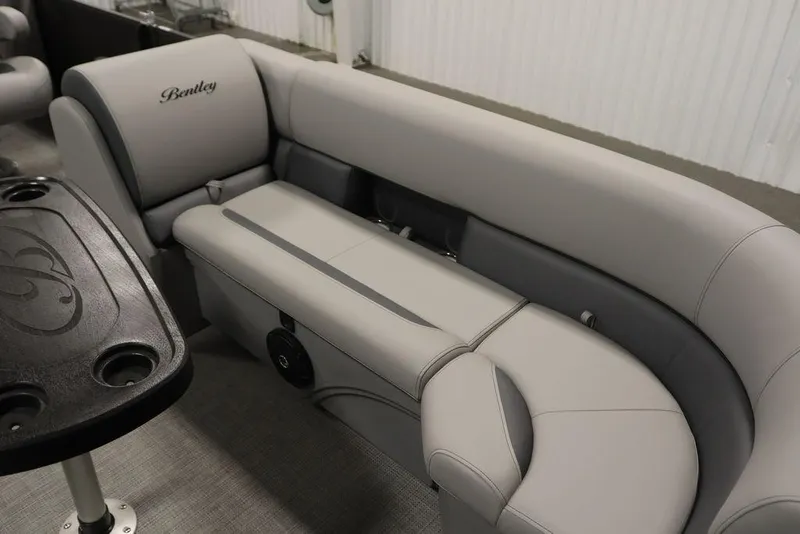 Slide: The Image of 2025 Bentley Pontoons 243 Navigator Tri-toon interior with luxurious seating and table. - 11