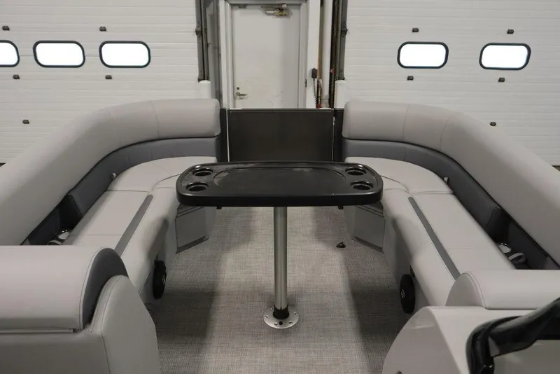 Slide: The Image of 2025 Bentley Pontoons 243 Navigator Tri-toon interior with gray seating and central table. - 13