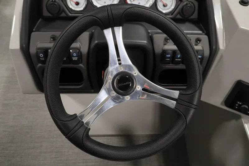Slide: The Image of 2025 Bentley Pontoons 243 Navigator Tri-toon steering wheel and dashboard controls. - 16