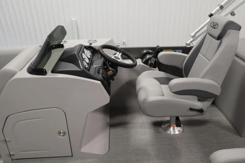 Slide: The Image of 2025 Bentley Pontoons 243 Navigator Tri-toon helm with modern steering and comfortable captain's chair. - 18